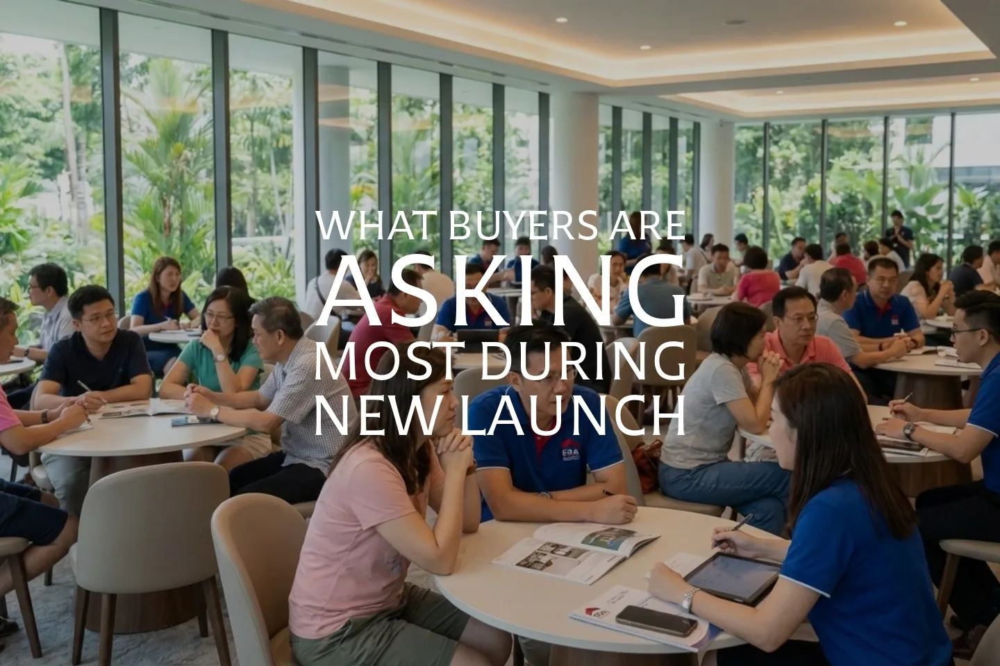 Buyers seated with property agents at a Singapore new launch showflat, discussing details before cheque submission